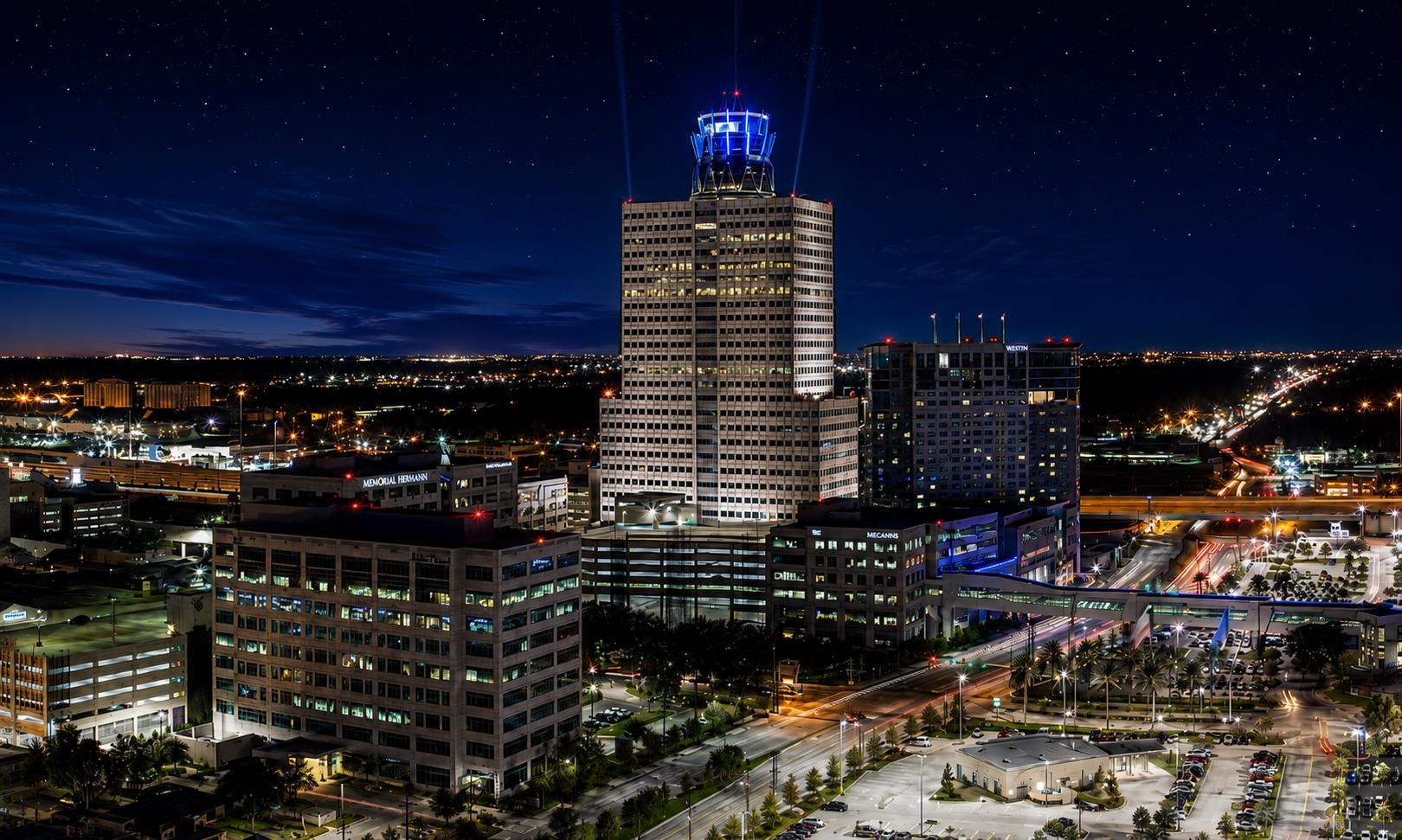 Memorial City skyline and I-10 corridor illuminated at night